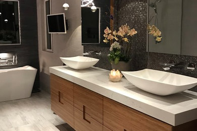 Bathroom - large modern master gray tile and stone tile porcelain tile and gray floor bathroom idea in San Francisco with flat-panel cabinets, light wood cabinets, a bidet, gray walls, a vessel sink, quartzite countertops and white countertops