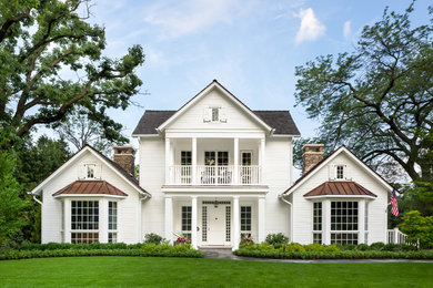 Large traditional white two-story wood exterior home idea in Chicago