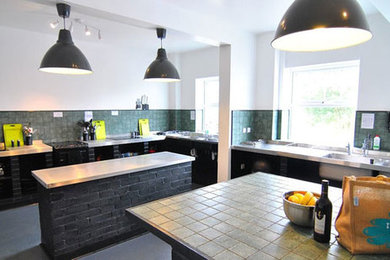Large rustic kitchen in Devon with a double-bowl sink, open cabinets, stainless steel worktops, green splashback, multiple islands, ceramic splashback, stainless steel appliances, lino flooring and grey floors.