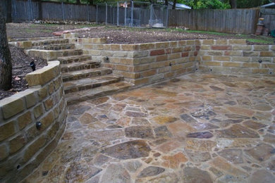 Large elegant backyard stone patio photo in Austin