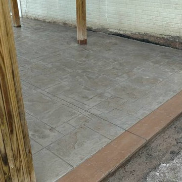 J-Stamped concrete patio with a step under the wood deck