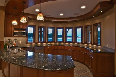Inspiration for a mid-sized contemporary u-shaped ceramic tile kitchen remodel in Grand Rapids with recessed-panel cabinets, medium tone wood cabinets, granite countertops, beige backsplash, matchstick tile backsplash, stainless steel appliances and a peninsula