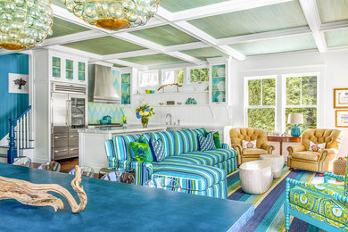 Example of a large beach style open concept carpeted living room design in Boston with white walls and no fireplace