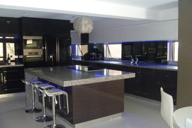 This is an example of a large modern galley eat-in kitchen in Perth with flat-panel cabinets and with island.