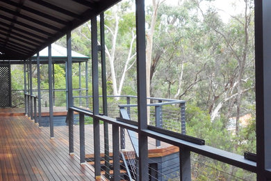 Photo of a mid-sized contemporary backyard deck in Adelaide with a pergola.