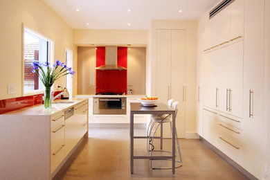 Contemporary kitchen in Melbourne with panelled appliances.