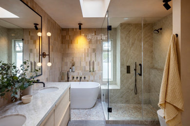 Bathroom - mid-sized 1950s master pink tile and terra-cotta tile cement tile floor, gray floor and double-sink bathroom idea in Vancouver with flat-panel cabinets, light wood cabinets, a bidet, pink walls, an undermount sink, quartzite countertops, a hinged shower door, beige countertops and a built-in vanity