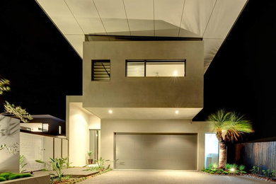 Inspiration for a contemporary two-storey beige exterior in Brisbane with a flat roof.