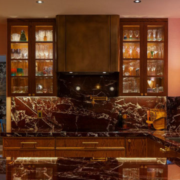 Custom Brass Range Hood in Elegant Wood & Marble Kitchen