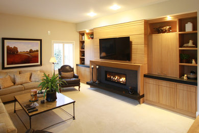 Family room - contemporary open concept carpeted family room idea in Portland with beige walls, a ribbon fireplace, a wood fireplace surround and a media wall