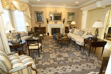 Example of a large classic formal and enclosed dark wood floor and blue floor living room design in New York with beige walls, a standard fireplace, a stone fireplace and no tv