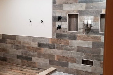 Freestanding bathtub - large rustic master multicolored tile and porcelain tile porcelain tile, brown floor, double-sink and wainscoting freestanding bathtub idea in Philadelphia with gray cabinets, beige walls, wood countertops and a freestanding vanity