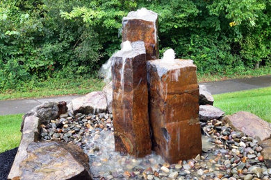 Photo of a small shade front yard stone water fountain landscape in Nashville.