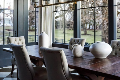 Mid-sized transitional marble floor, white floor and wallpaper enclosed dining room photo in Chicago with black walls, a standard fireplace and a wood fireplace surround