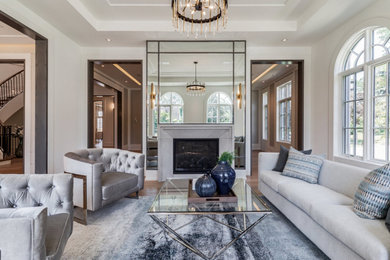 Inspiration for a large contemporary open concept light wood floor, brown floor and tray ceiling living room remodel with a standard fireplace and a stone fireplace