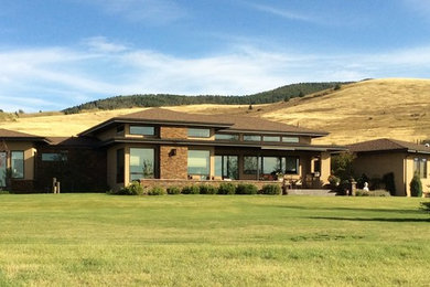 Inspiration for a large rustic beige mixed siding exterior home remodel in Other