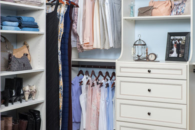 Mid-sized trendy gender-neutral dark wood floor walk-in closet photo in Orange County with open cabinets and white cabinets