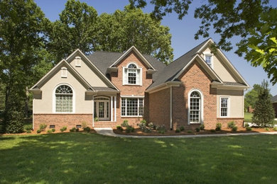 Example of a mid-sized classic beige two-story mixed siding exterior home design in Charlotte