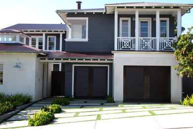 This is an example of a beach style two-storey exterior in Orange County with wood siding.