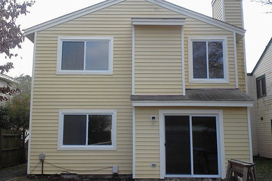 Yellow two-story vinyl exterior home photo in Other