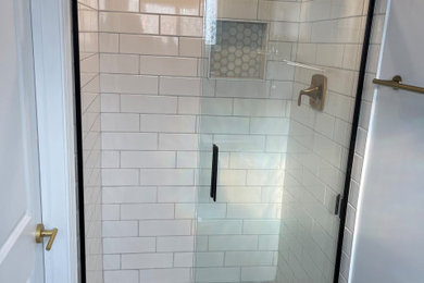 Inspiration for a mid-sized contemporary 3/4 bathroom remodel in New York with shaker cabinets, black cabinets and a freestanding vanity