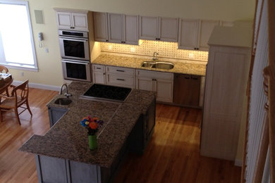 Enclosed kitchen - traditional l-shaped enclosed kitchen idea in Boston with a double-bowl sink, granite countertops and stainless steel appliances