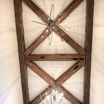 Hand Hewn Timbers in a Geometric X Pattern on a Two Story Foyer Ceiling