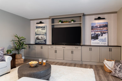 Mid-sized transitional open concept family room in St Louis with a home bar, beige walls, medium hardwood floors, a built-in media wall and beige floor.
