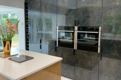 Photo of a contemporary kitchen in Essex with quartz worktops, white floors and white worktops.