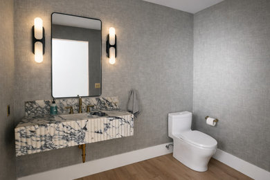 Inspiration for a mid-sized 1950s gray tile powder room remodel in San Francisco with a one-piece toilet, a vessel sink, marble countertops, multicolored countertops and a floating vanity