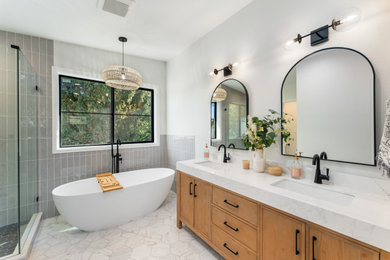 Freestanding bathtub - transitional master white floor and double-sink freestanding bathtub idea in Seattle with shaker cabinets, medium tone wood cabinets, white walls, an undermount sink, white countertops and a freestanding vanity