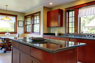 Example of a mid-sized classic single-wall ceramic tile and beige floor eat-in kitchen design in Montreal with a double-bowl sink, shaker cabinets, dark wood cabinets, granite countertops, stainless steel appliances and an island