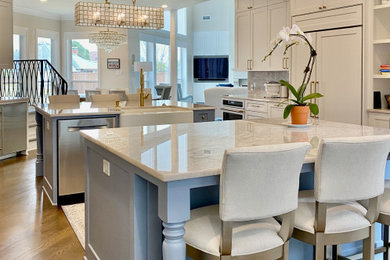 Example of a transitional kitchen design in Dallas with shaker cabinets and two islands