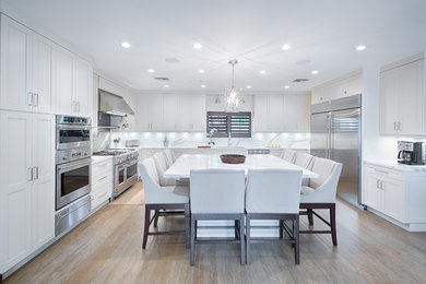 Design ideas for a transitional kitchen in Miami with shaker cabinets, white cabinets, quartz benchtops and with island.