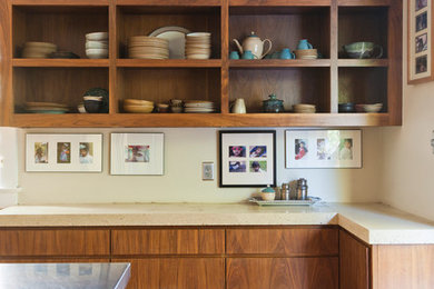 Inspiration for a mid-sized contemporary l-shaped medium tone wood floor eat-in kitchen remodel in New Orleans with flat-panel cabinets, medium tone wood cabinets, quartz countertops, an island, beige backsplash, stainless steel appliances and an undermount sink
