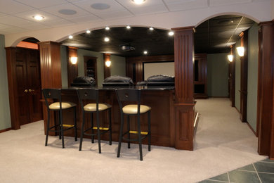 Basement - large transitional underground carpeted and beige floor basement idea in Other with green walls