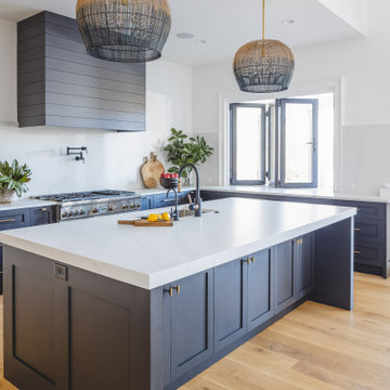 Custom Kitchen with Dark Island, Light Wood Cabinetry & Statement Pendants
