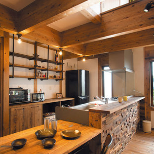 Photo of an asian single-wall kitchen in Other with a single-bowl sink, flat-panel cabinets, medium wood cabinets, light hardwood floors, a peninsula, brown floor and brown benchtop.