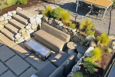 Example of a trendy backyard concrete paver patio design in Seattle with a bbq area