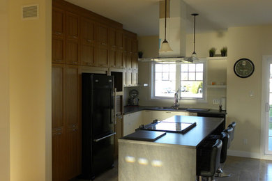 Example of a transitional kitchen design in Montreal with an island
