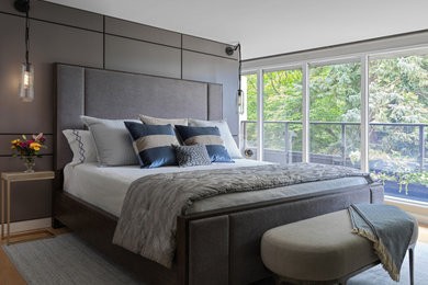 Mid-sized trendy master light wood floor and brown floor bedroom photo in Toronto with white walls