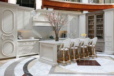 Kitchen - contemporary l-shaped kitchen idea in Atlanta with recessed-panel cabinets, beige cabinets, marble countertops, white backsplash and an island