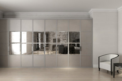 Spacious contemporary bedroom with mirror-faced wardrobes