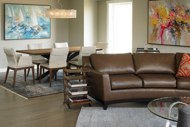 Living room - mid-sized contemporary formal and open concept medium tone wood floor and brown floor living room idea in Calgary with brown walls, a standard fireplace, a stone fireplace and no tv