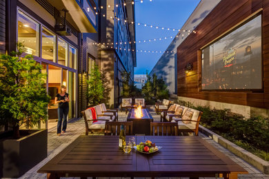 Patio - large contemporary courtyard concrete paver patio idea in Portland with a fire pit