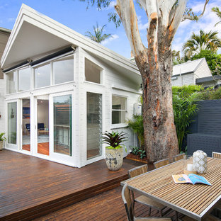 Contemporary backyard deck in Sydney with no cover.