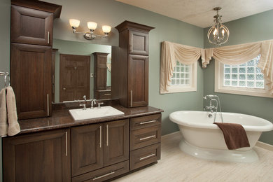 Design ideas for a large traditional bathroom in Other with shaker cabinets, dark wood cabinets, engineered quartz benchtops, a freestanding tub, a curbless shower, multi-coloured tile, porcelain tile, a one-piece toilet, green walls, vinyl floors and a drop-in sink.