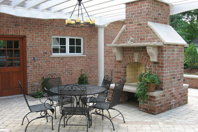 Photo of a traditional backyard patio in Milwaukee with natural stone pavers.
