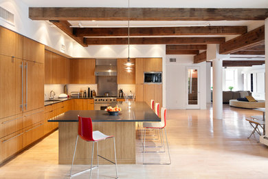 Large trendy light wood floor kitchen photo in New York with medium tone wood cabinets, solid surface countertops and an island