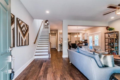 Mid-sized transitional open concept medium tone wood floor family room photo in Orange County with gray walls